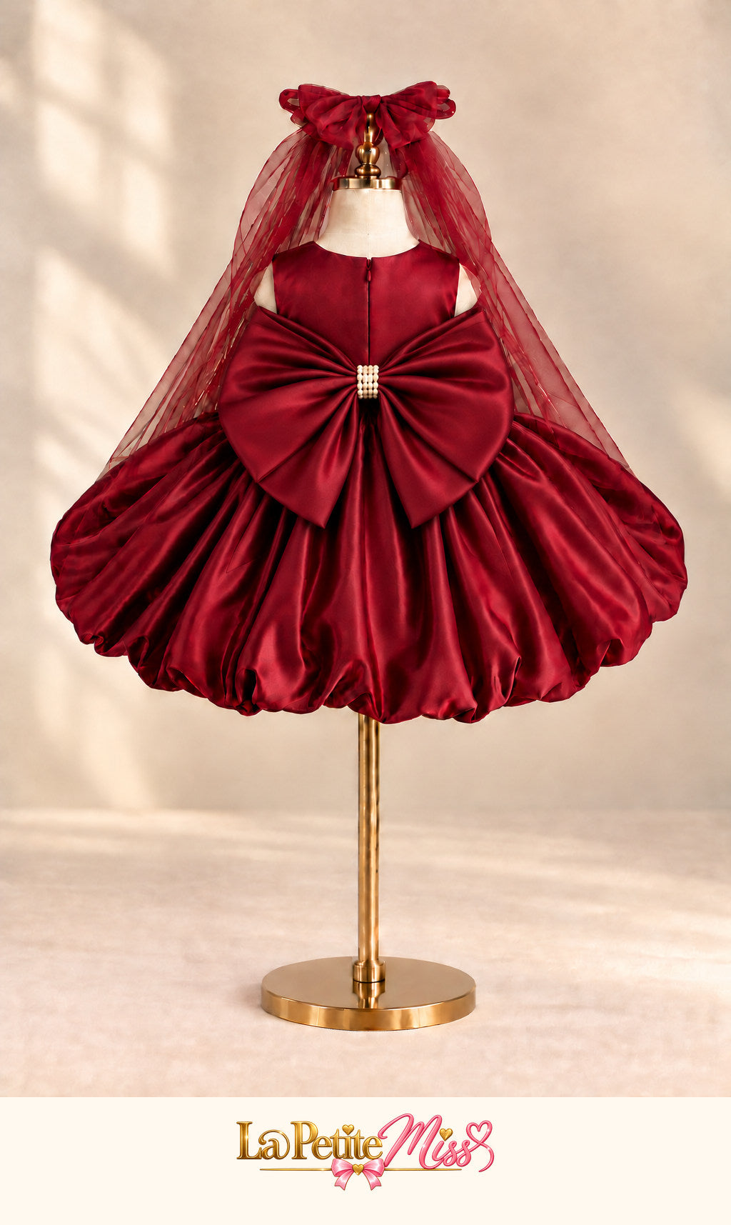 Empress Dress by La Petite Miss, back view of the burgundy satin girls dress with tulle cape