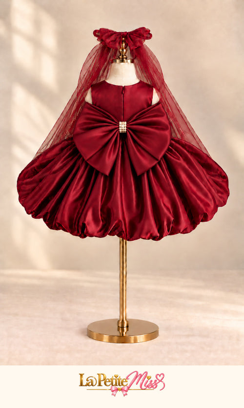 Empress Dress by La Petite Miss, back view of the burgundy satin girls dress with tulle cape